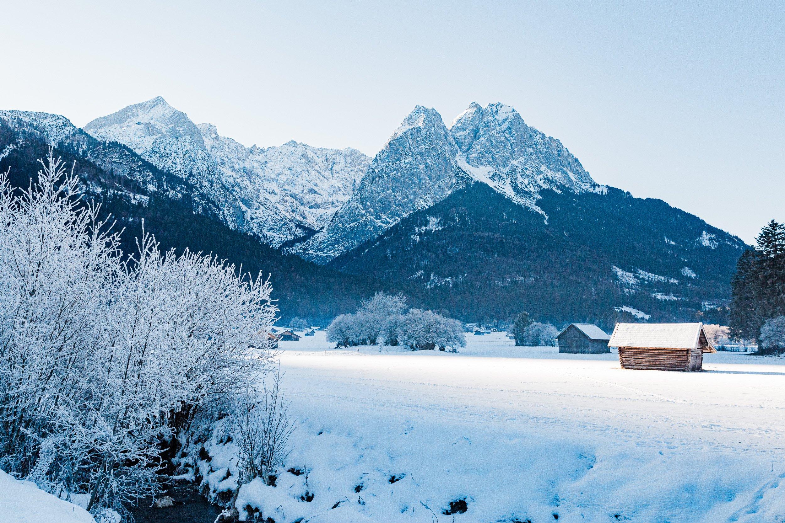 Snow covered fields with Alpspitz and Waxenstein peaks